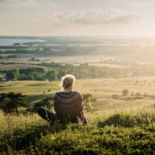 a mature woman looking out over the countryside